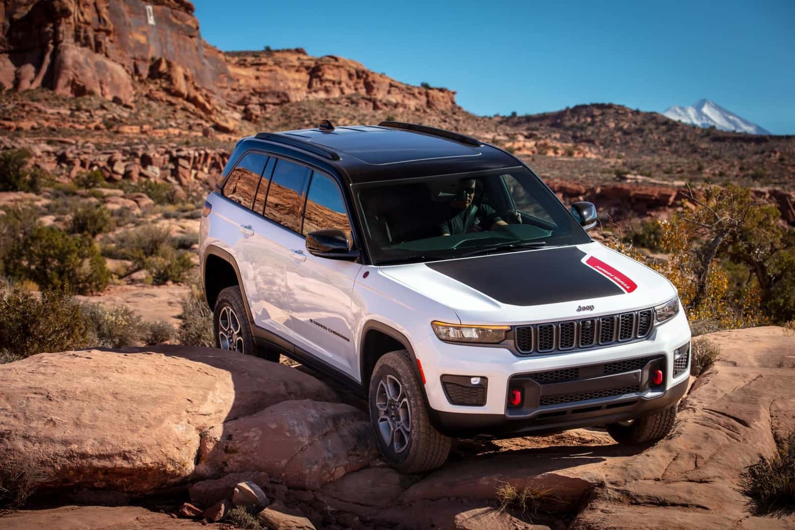 2022 Jeep Grand Cherokee Trailhawk white off roading on boulders