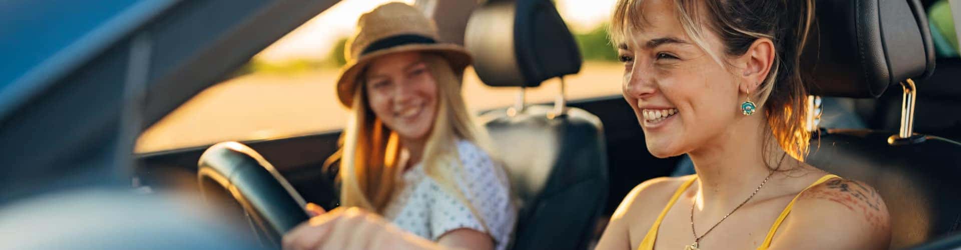 Two girls driving their used vehicle