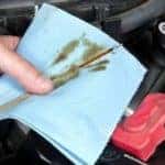 Man Cleaning Oil Stick