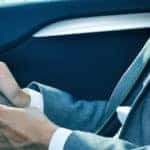 Businessman using a tablet in a car