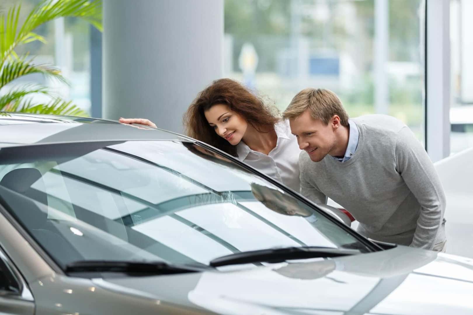 Couple Browsing Used Cars at the Dealership