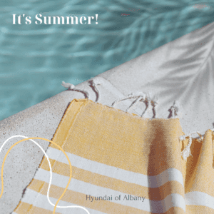 "it's summer" is written on a photograph of a beach town next to the pool