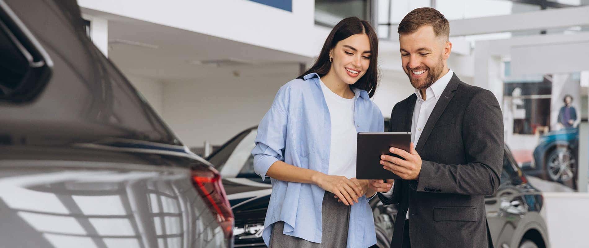 Young woman reviewing the details of her vehicle