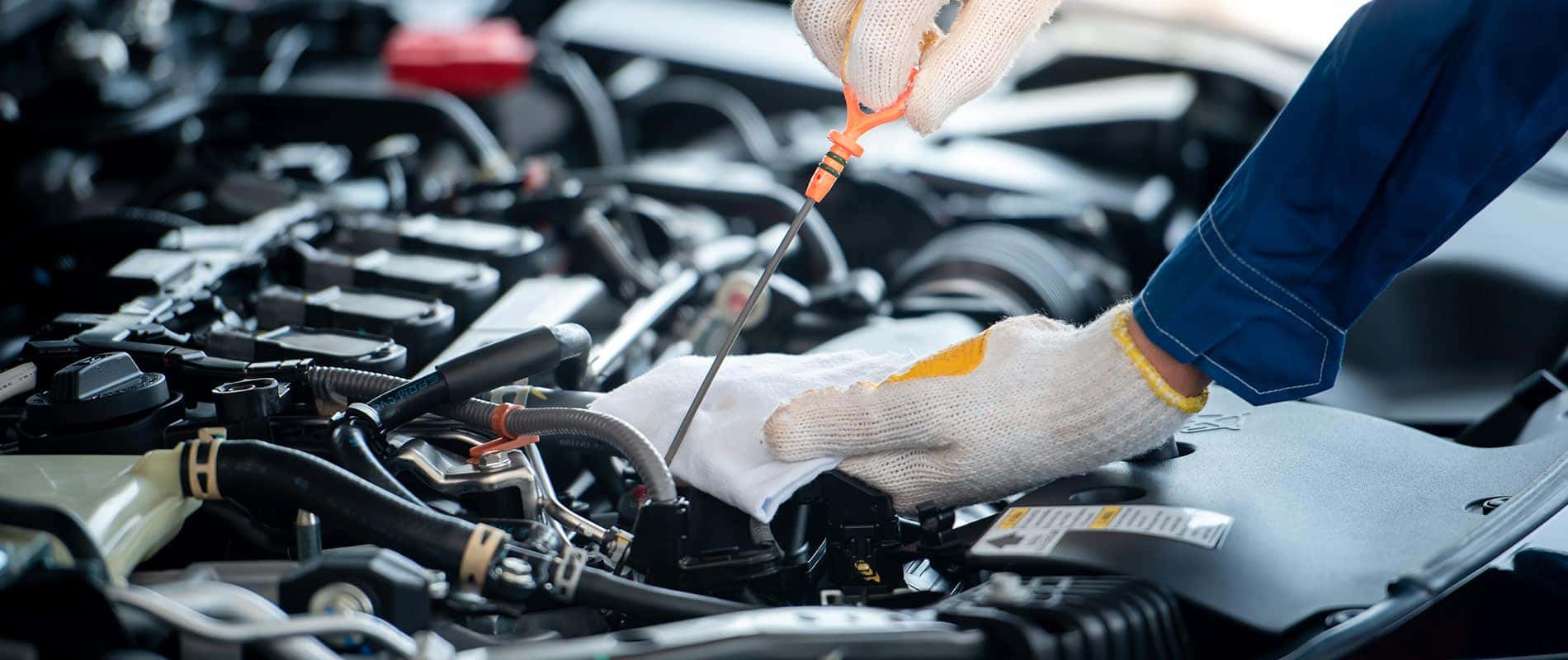 Technician checks the oil in a Hyundai engine