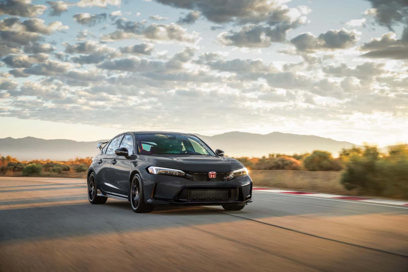 Gray 2027 Honda Civic Type R in motion at golden hour