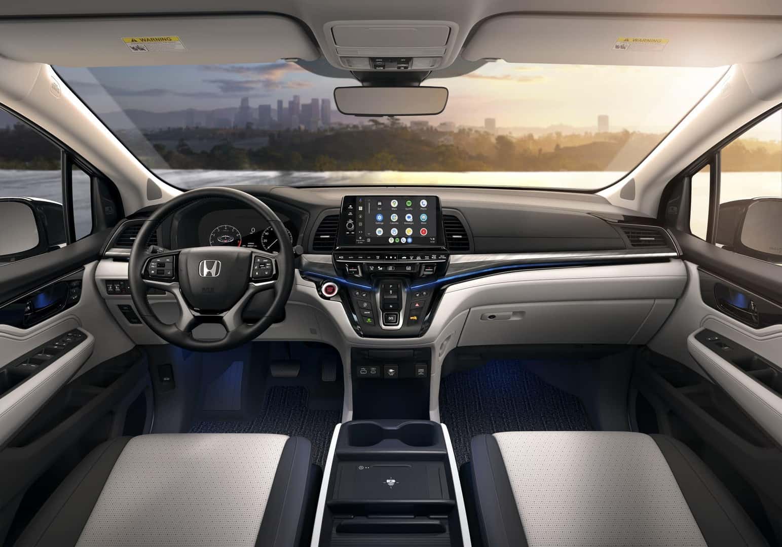 Honda Odyssey front cabin with touchscreen, steering wheel and wireless phone charging tray