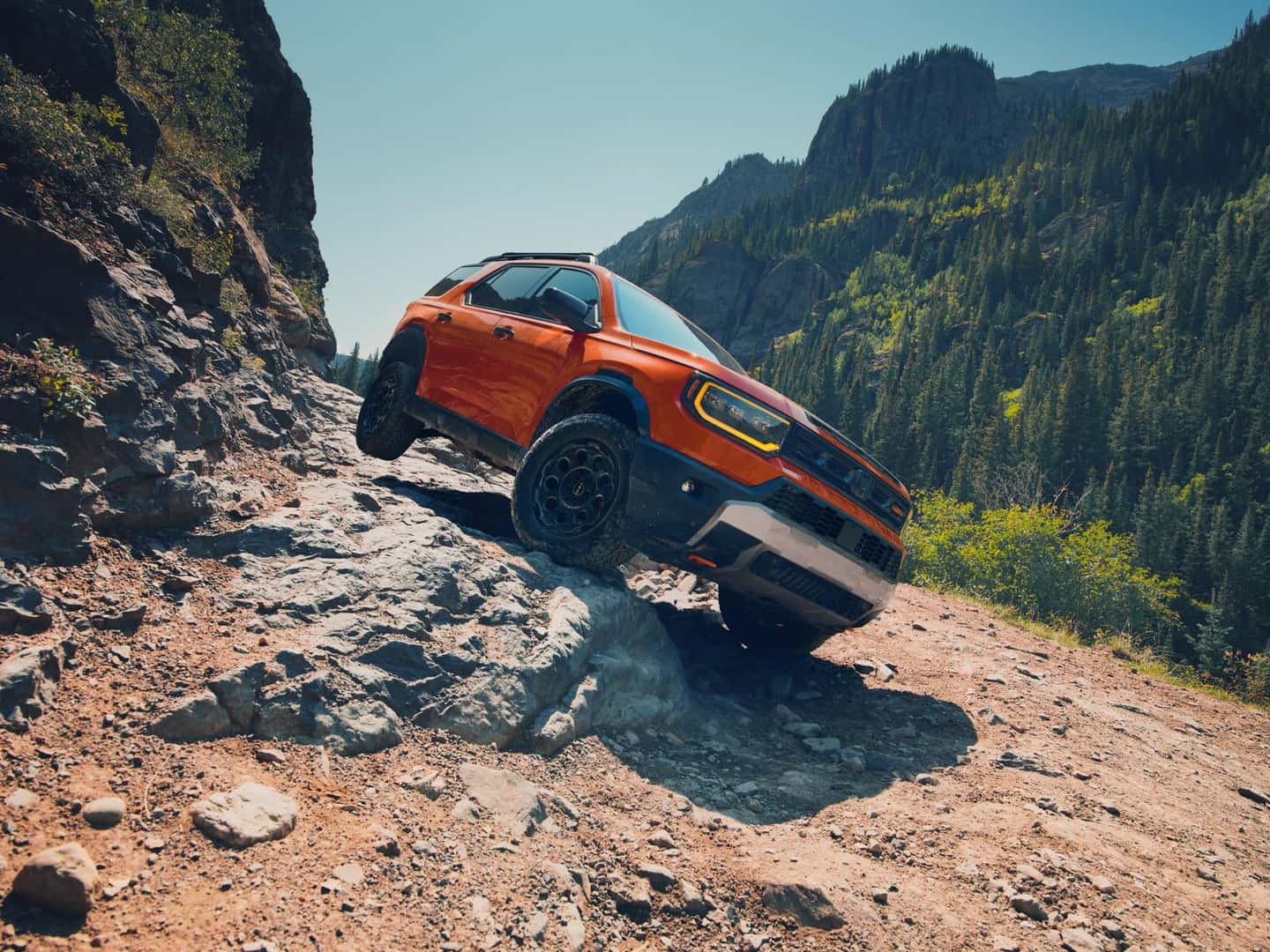 2027 Honda Passport TrailSport Elite in Sunset Orange on a rocky trail