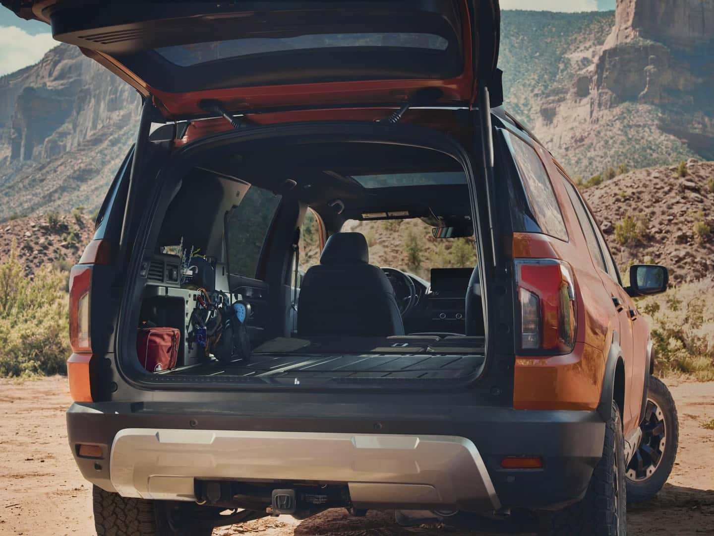 2027 Honda Passport cargo area with rear seats folded and outdoor gear