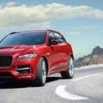 2019 Red Jaguar F-PACE Front View driving on snowy mountain highway