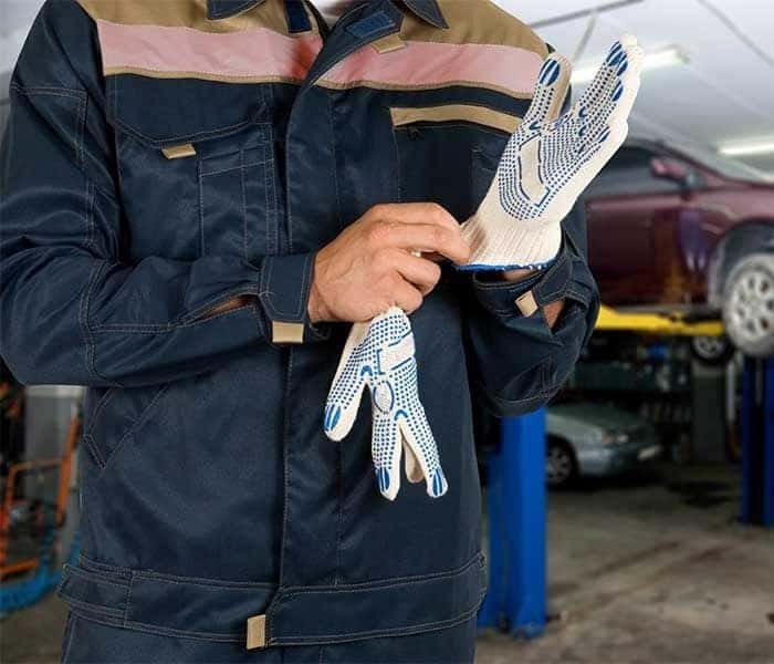 Auto Mechanic Putting on Gloves
