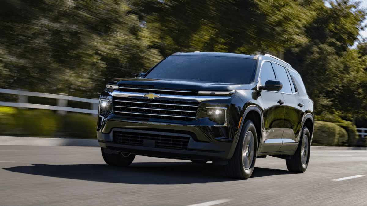 A black Chevrolet Traverse driving down the road