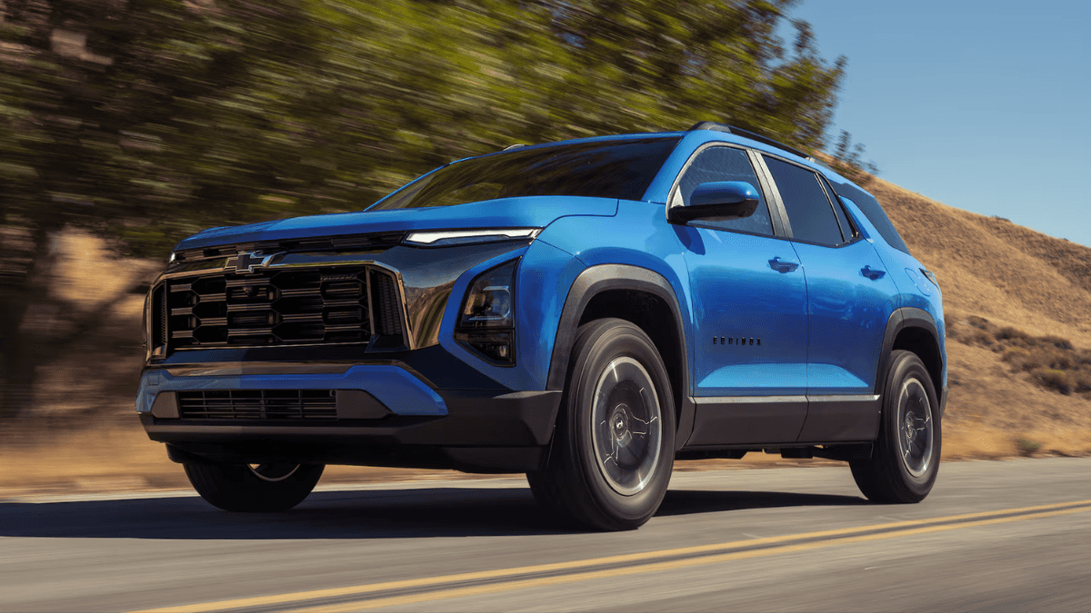 A lower angle image of a blue Chevrolet Equinox driving on a road