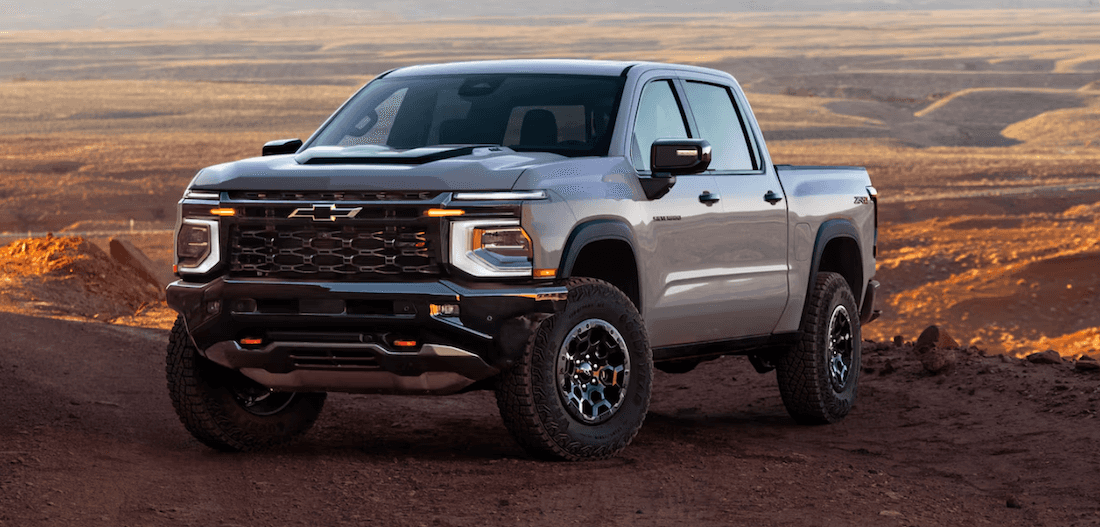 Front and side view of the 2027 Chevrolet Silverado 1500 in an off-road setting