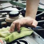 mechanic checking oil dipstick