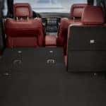 2019 jeep grand cherokee interior view of cargo area with rear seat partially down and red leather interior