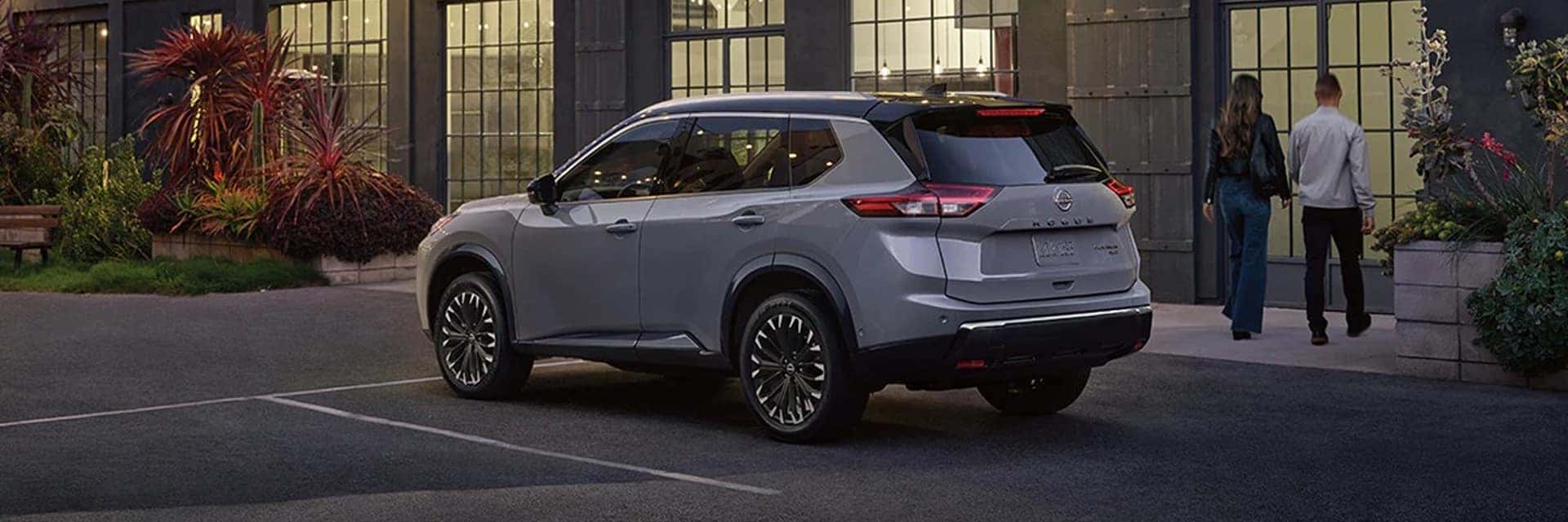 couple by parked nissan rogue