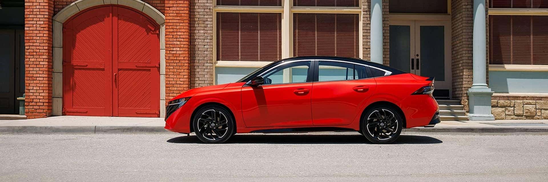red 2025 nissan sentra parked in front of building
