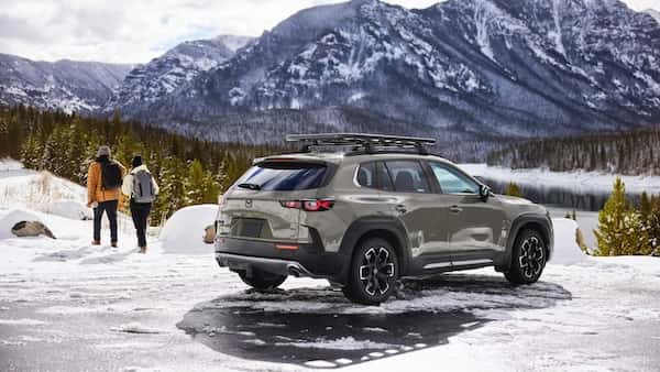 Mazda CX-50 SUV navigating a snow-covered mountain road