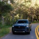 Mazda CX-50 SUV driving on a scenic winding road