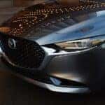 close-up of a certified pre-owned Mazda3 front grille and LED headlight