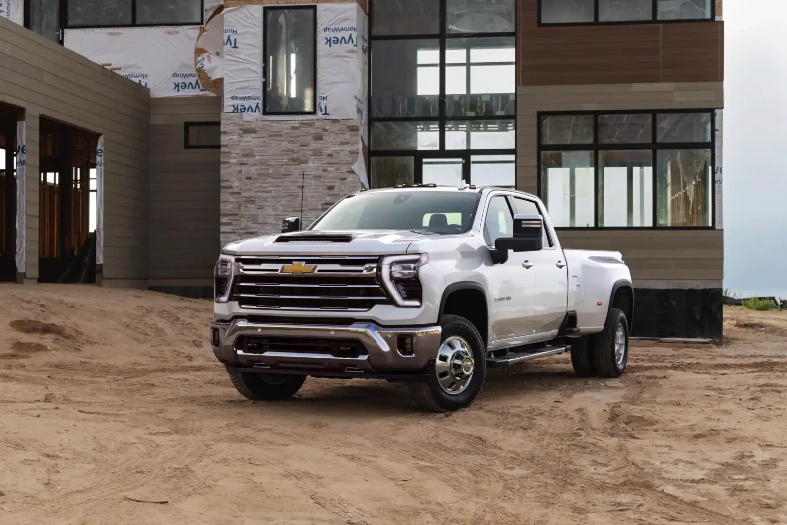 Chevrolet Silverado 3500 HD LTZ Truck parked in front of a new construction house 