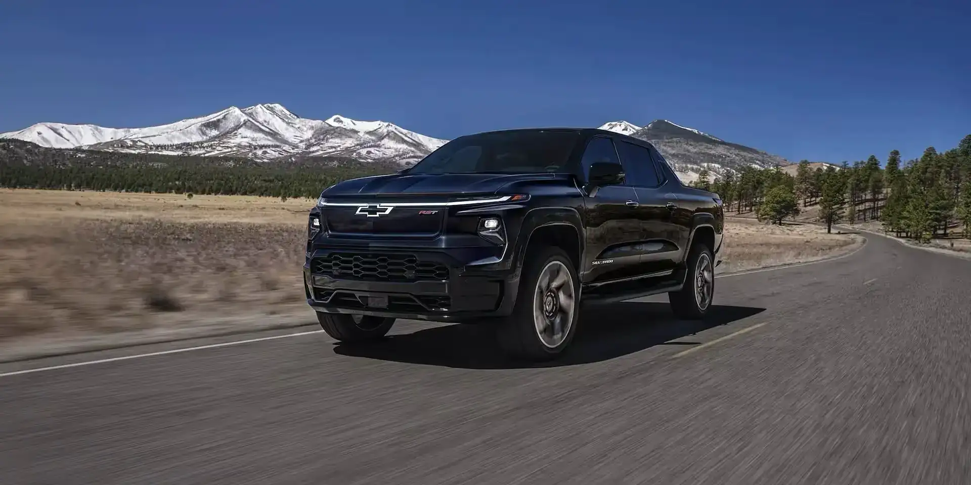 Black Chevrolet Silverado EV on the road 