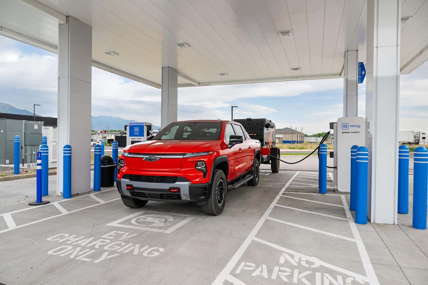 The Fast-Charging 2026 Chevrolet Silverado EV Trail Boss Parked And Being Charged At A Public Charging Station
