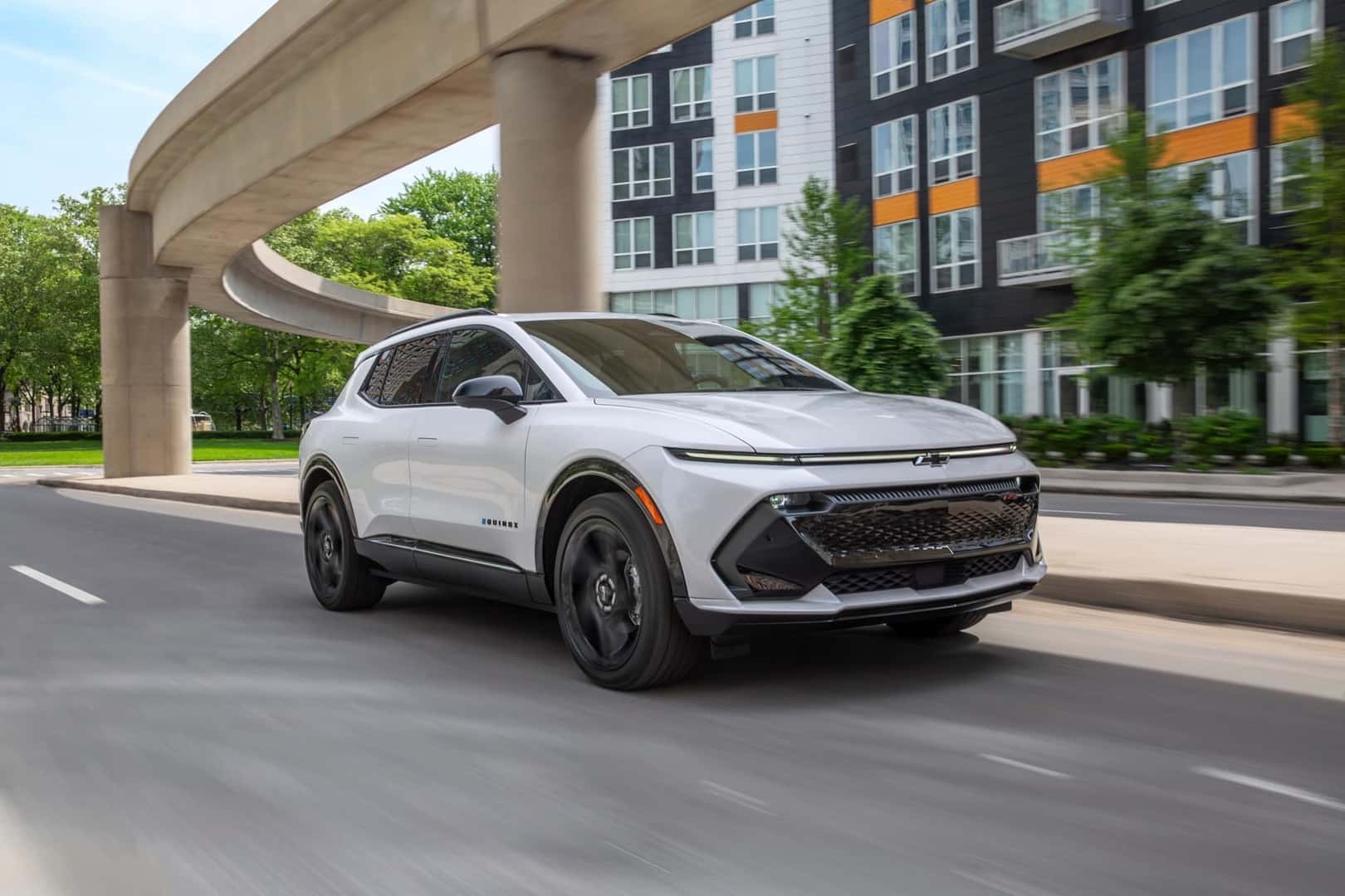 The Attractive 2026 Chevrolet Equinox EV, Cruising Through A Cityscape In Sunny Weather