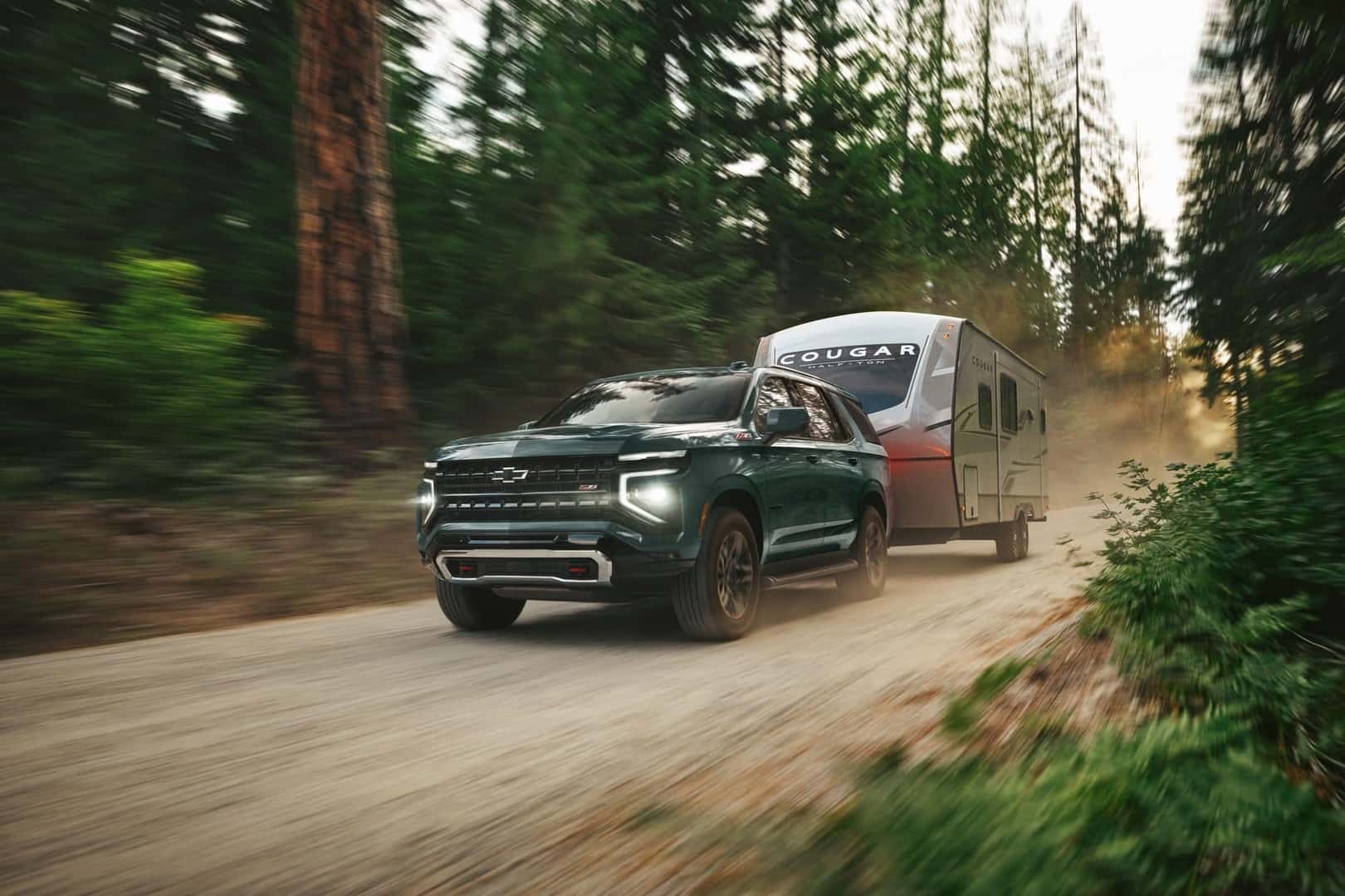 The Powerful And Sturdy 2026 Chevrolet Tahoe Driving On Dirt Roads, Towing A Hefty Trailer With Ease