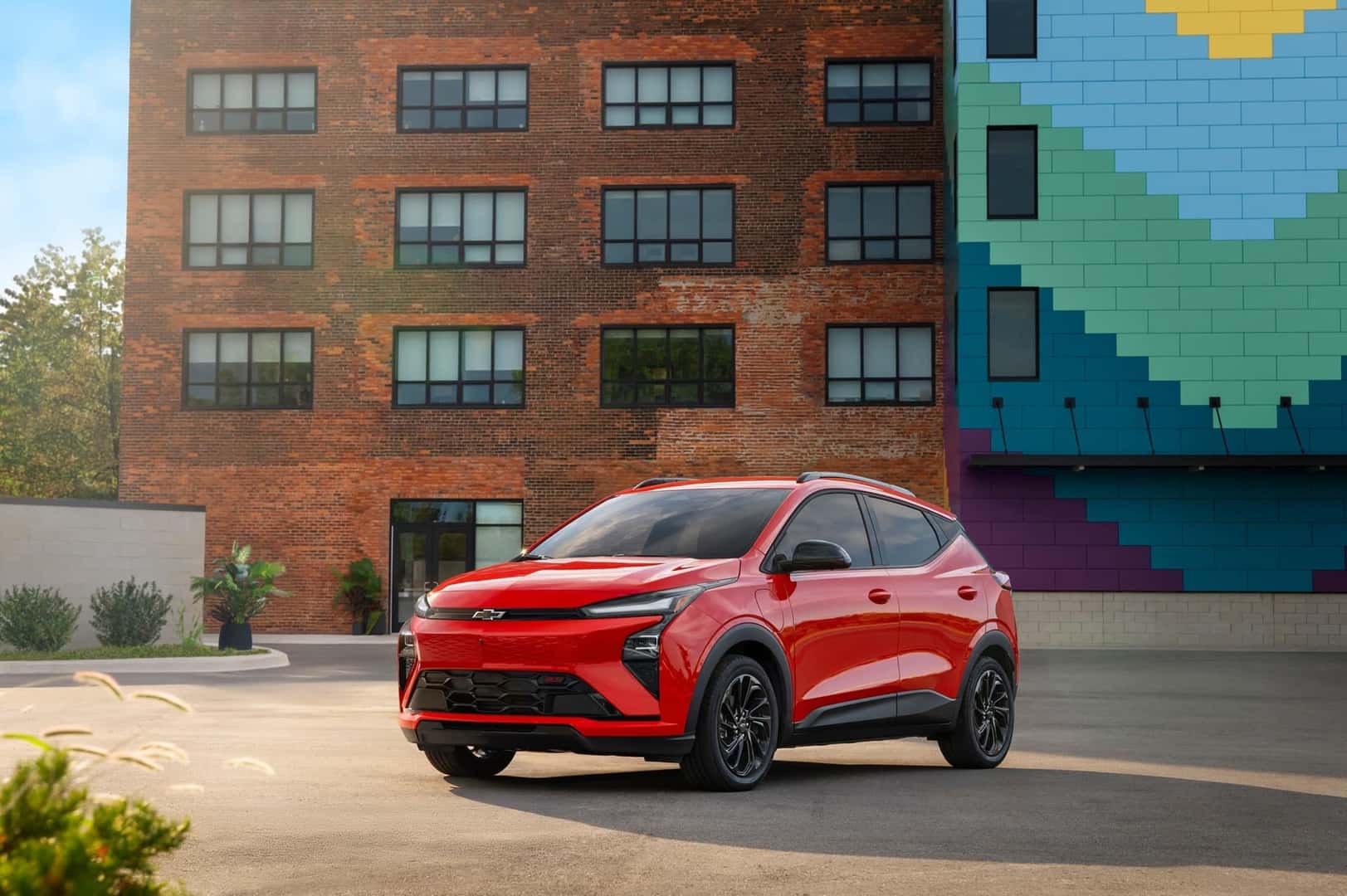 The All Electric Chevrolet Bolt, Parked In Front A Beautiful Brick Building And Marvelous Mural