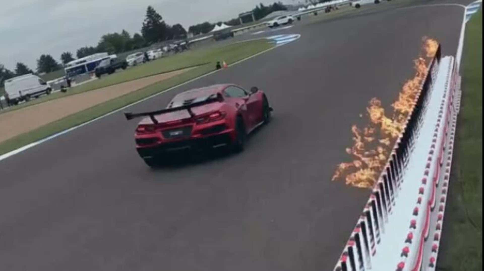 A Very Long And Narrow Red, White, And Blue Birthday Cake Being Blown Out By A Speeding, American Corvette