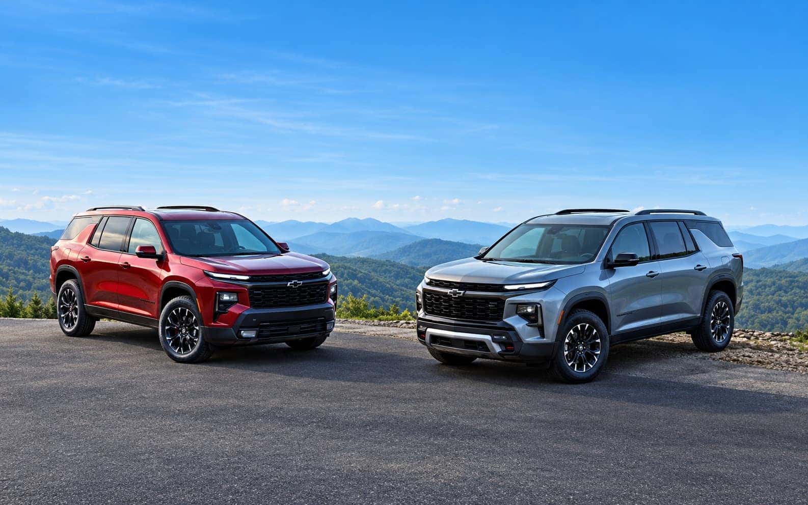 Two 2025 Chevrolet Equinox SUVs overlooking the mountains