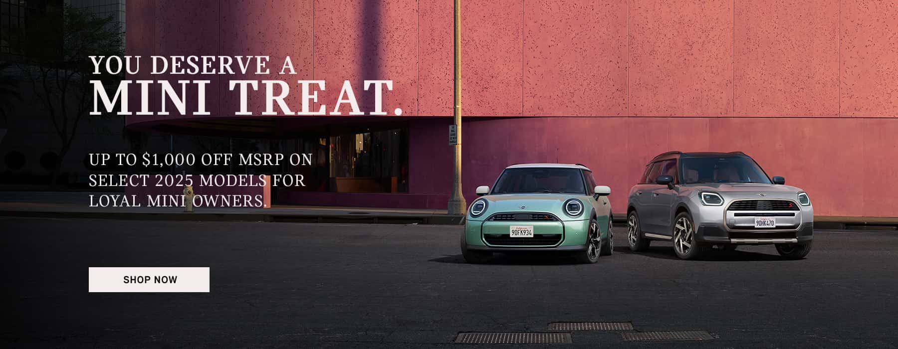 ¾ left view of a white 2025 MINI Cooper 4 Door parked on a city street with an orange building in the background.