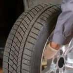 Mechanic Putting Tire on Car