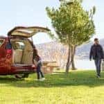 2018 Chrysler Pacifica parked at a lake with family loading stuff in the cargo