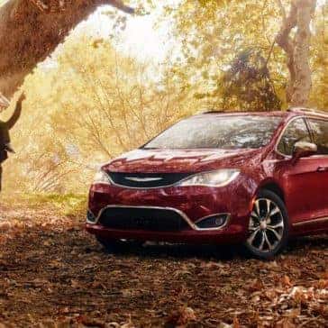 2018 Chrysler Pacifica parked in forest by a tree