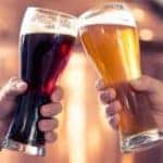 Two people clinking their beer glasses