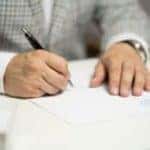 A man signing a paper