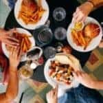 People eating burgers around a table