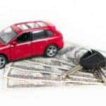 A small car, keys, and dollar bills