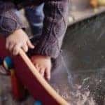 A child's hands as they are playing outside