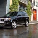 A black 2012 Ford Escape is parked on a city street in Philadelphia, PA.