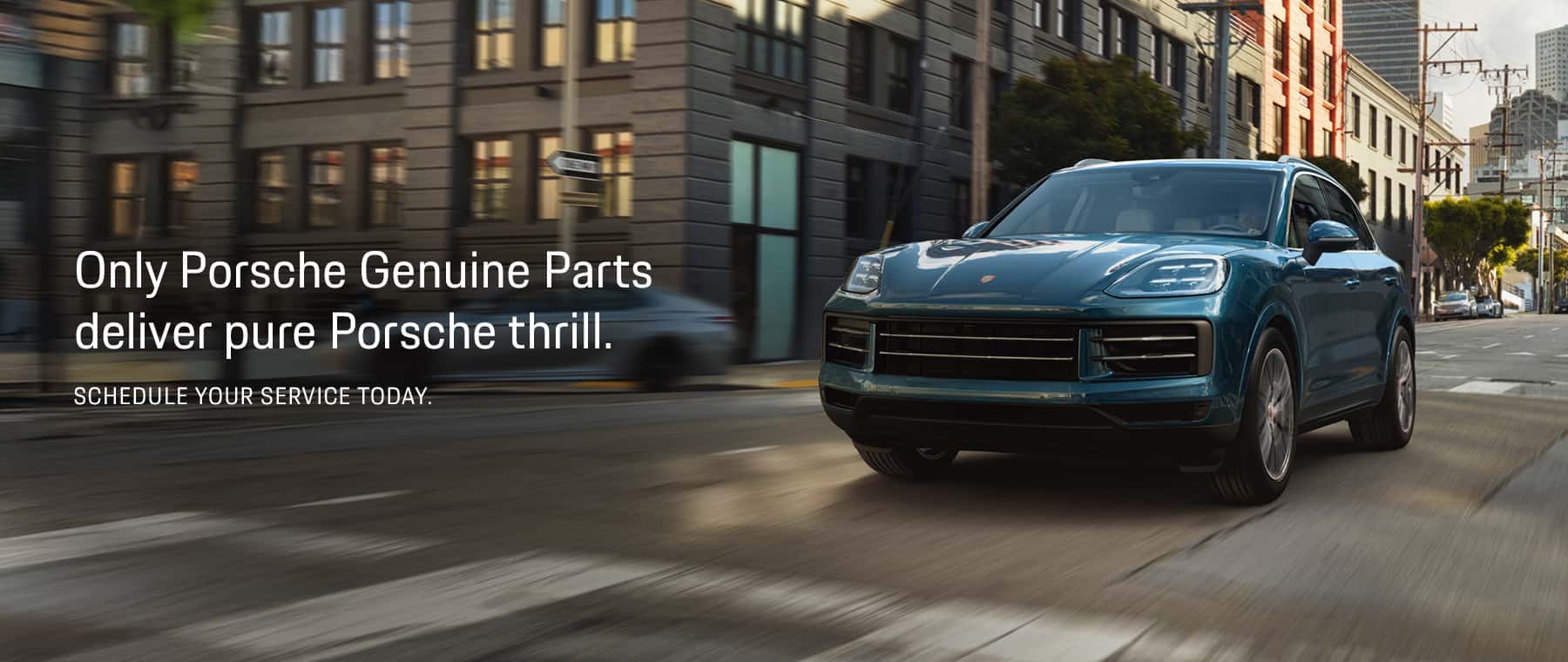 Image of Cayenne driving on city street. Only Porsche Genuine Parts deliver pure Porsche thrill. Schedule your service today.