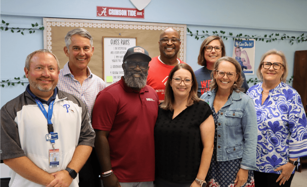 An image displaying Taylor Hood and the members of LEI in a classroom with four