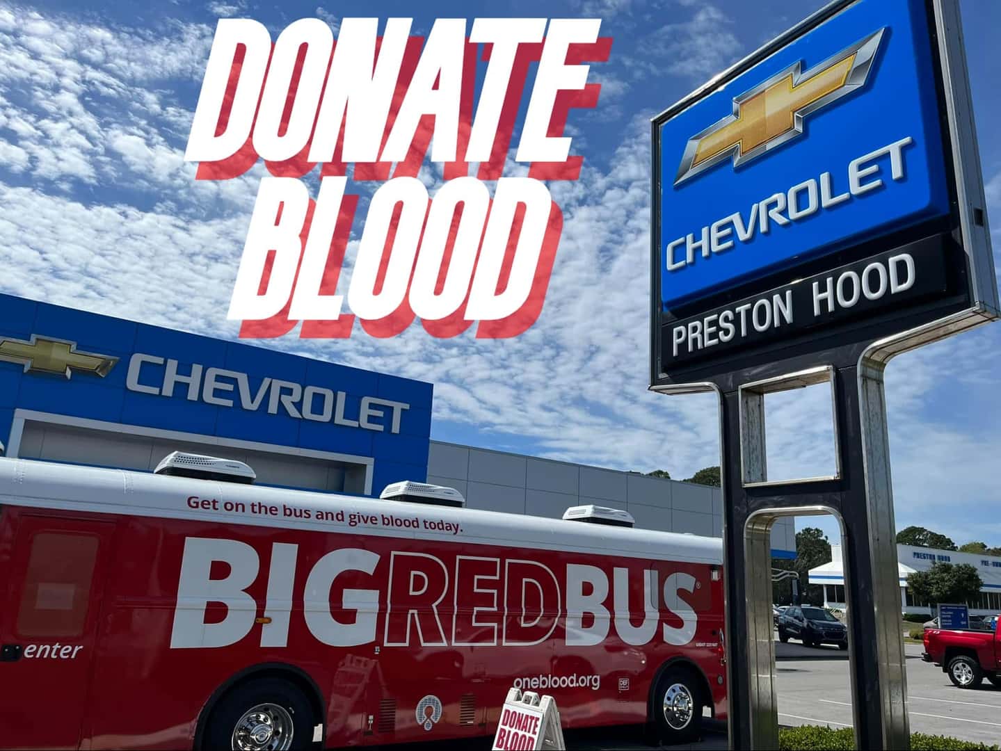 Big Red Bus Parked In Front of Preston Hood Chevrolet