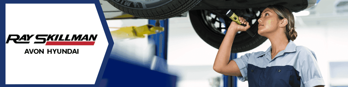 Hyundai Service Center Indianapolis - a woman inspecting the undercarriage of a vehicle