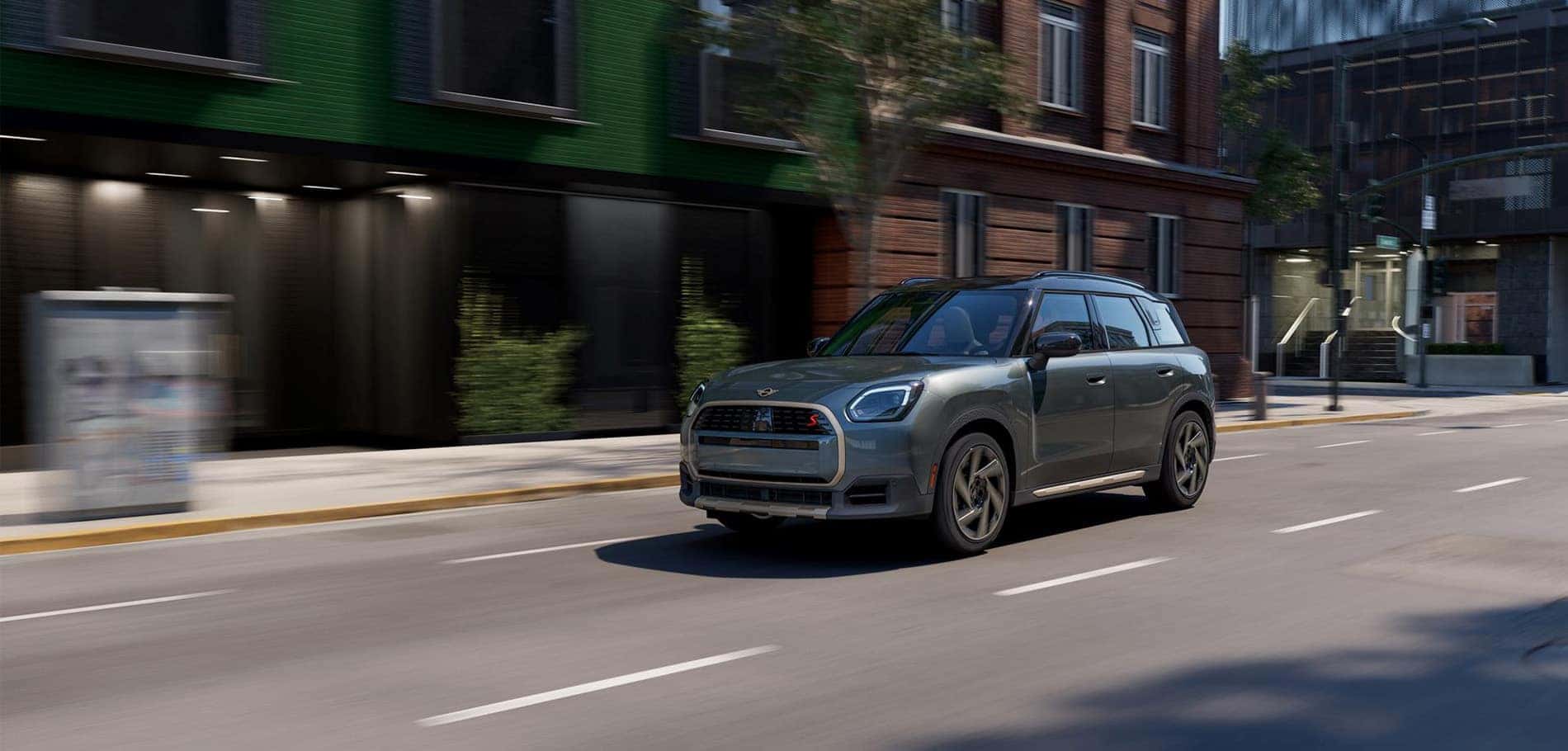 Gray MINI Countryman driving through town