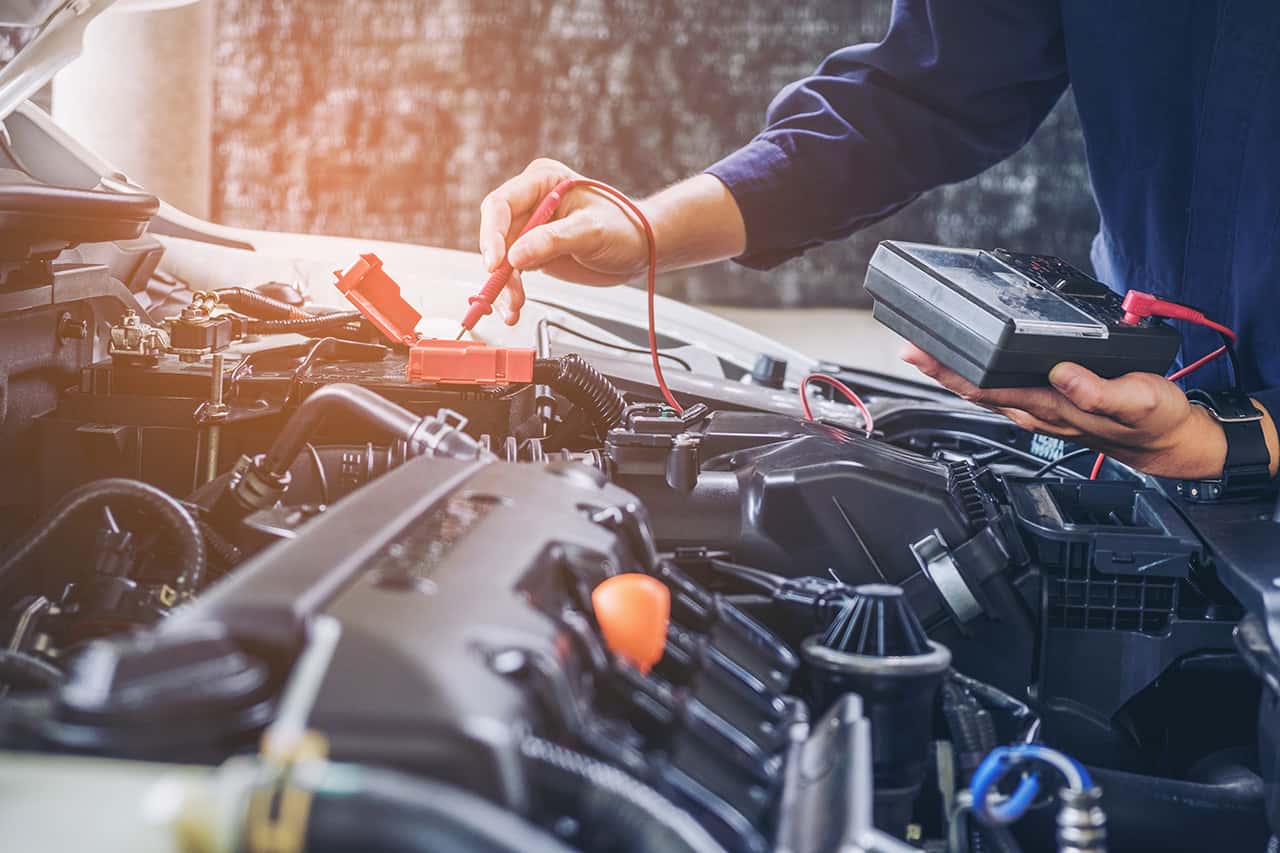 Toyota service technician running diagnostics on a car
