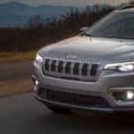 The 2019 Jeep Cherokee driving down the road.