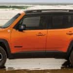 Orange 2019 Jeep Renegade on beach shore